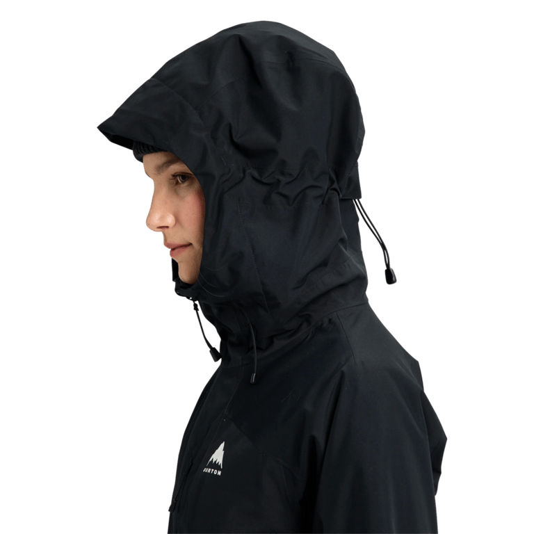 Side profile of a black Burton Reserve Insulated Snowboard Jacket for women with the adjustable hood up.