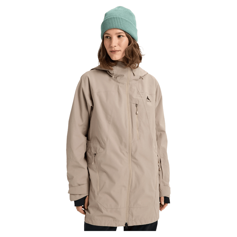 Women's beige Burton Reserve Insulated Snowboard Jacket with a long fit, hood, and chest pocket on a model in a teal beanie.