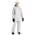 Woman wearing a light grey and white two-tone Burton Reserve Insulated Snowboard Jacket with a hood and zip pockets.