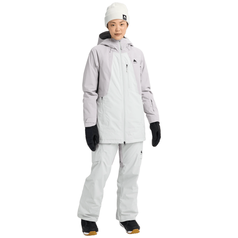 Woman wearing a light grey and white two-tone Burton Reserve Insulated Snowboard Jacket with a hood and zip pockets.