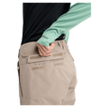 Close-up of the Velcro-flap back pocket on tan Burton Reserve Insulated Snowboard Pants for women.