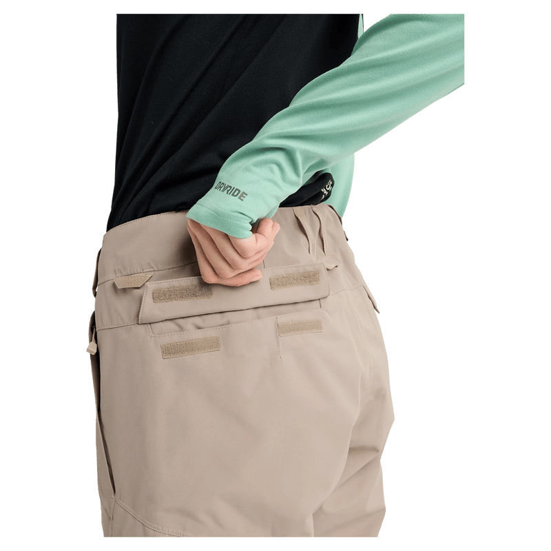 Close-up of the Velcro-flap back pocket on tan Burton Reserve Insulated Snowboard Pants for women.