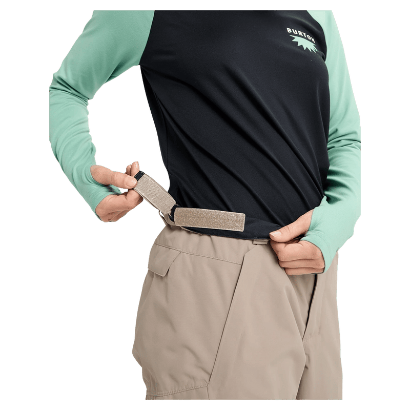 Close-up of tan Burton Reserve Insulated Snowboard Pants showing the adjustable velcro waist strap.