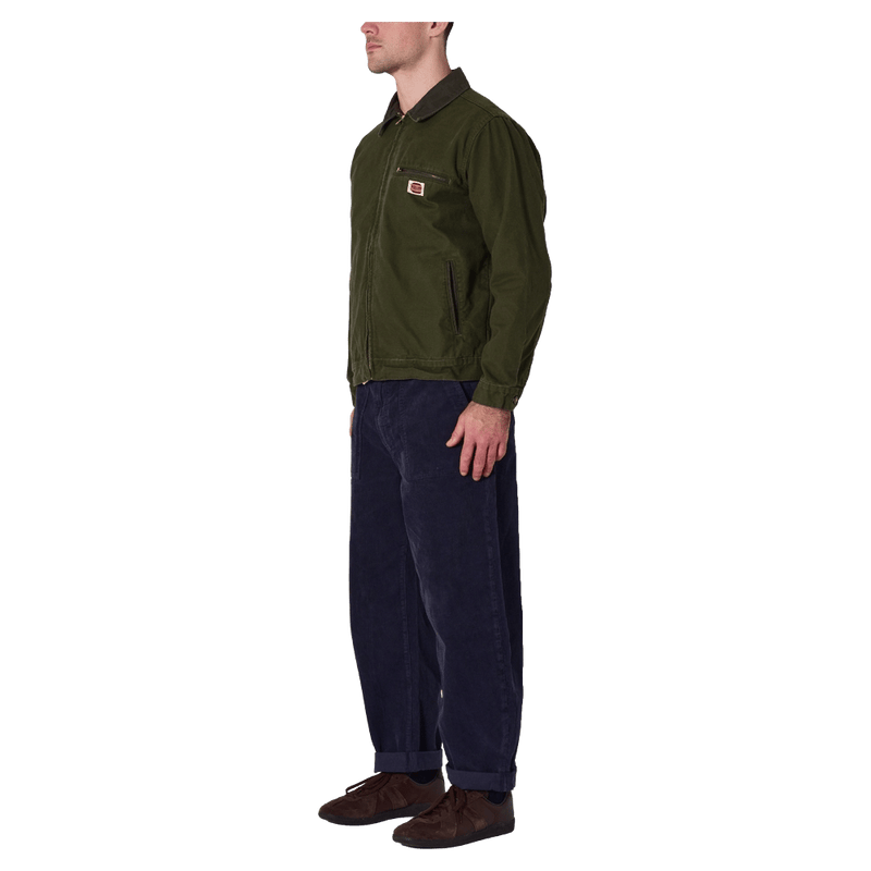 Side view of man in the Rollas Canvas Miner Jacket in colour Mangrove.