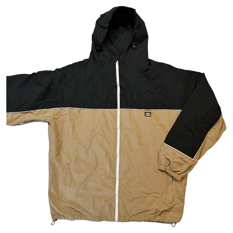 CHECKtheFeed VX Daily Snowboard Jacket in black and tan with white zipper, worn by a snowboarder on a snowy mountain.
