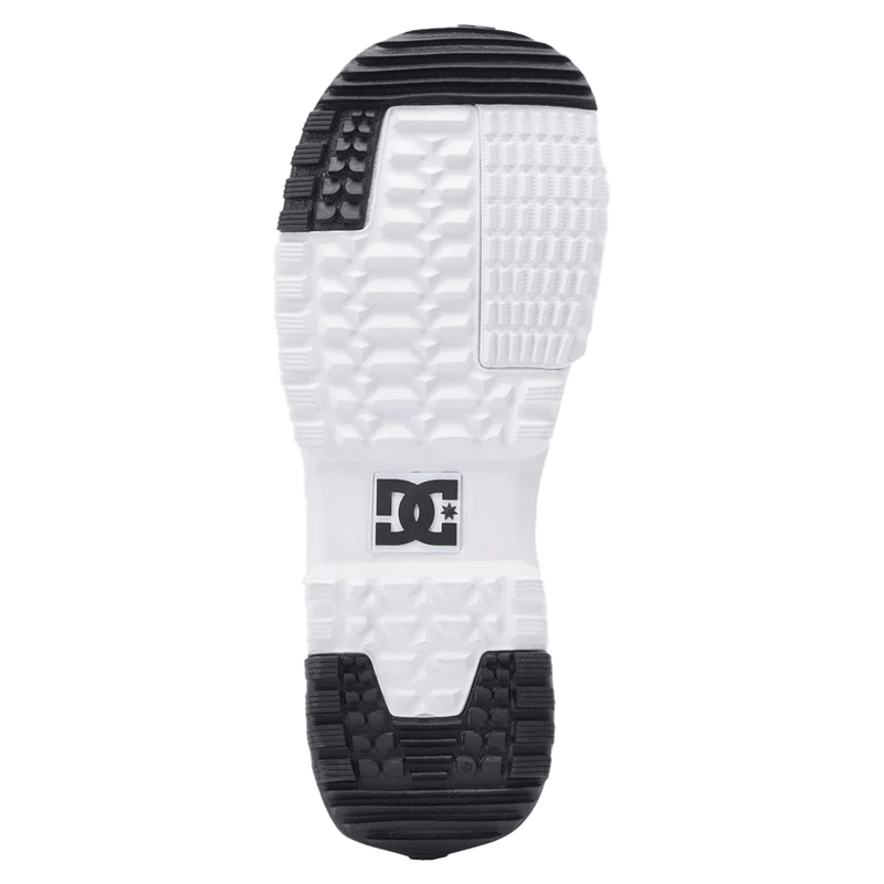 White and black textured outsole of a DC Control BOA snowboard boot featuring a central DC logo and deep tread pattern.
