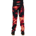 Rear view of Dharco Kids Gravity Pants in a red and black abstract pattern with white logos on the back and lower leg.