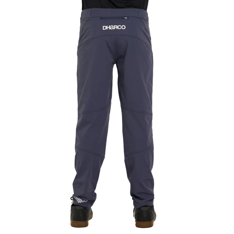Back view of slate grey Dharco Gravity Kids bike pants with white logo, zippered rear pocket, and tapered legs.