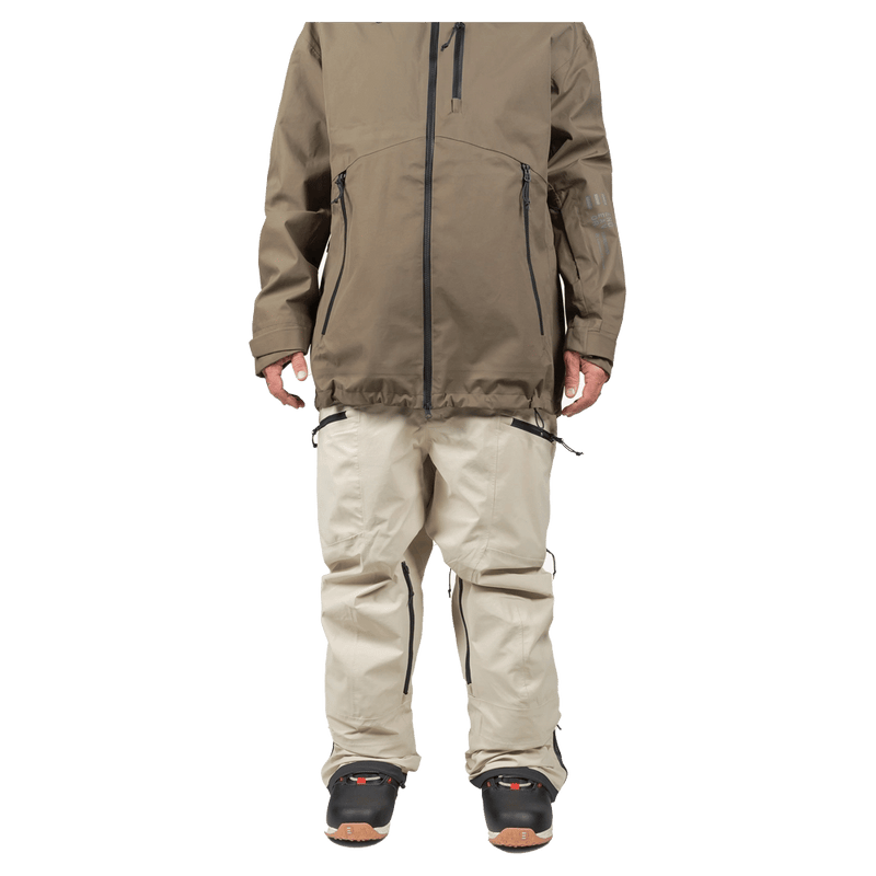 Beige Endeavor 3L Shelter Bib Snowboard Pants with black zippered pockets and relaxed fit, front view.