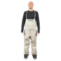 Beige Endeavor 3L Shelter Bib Snowboard Pants with black branded suspenders and zippered pockets on a male model.