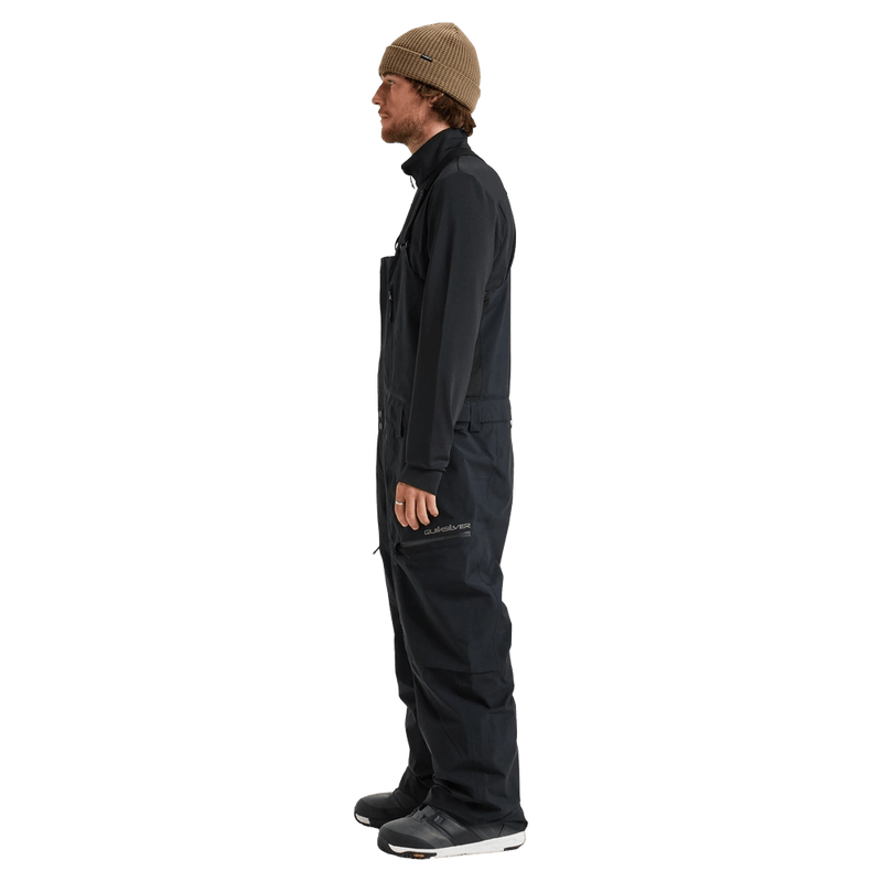 Side view of black Quiksilver Altostratus Street Gore-Tex Bib Snowboard Pants with zippered thigh pocket and logo.