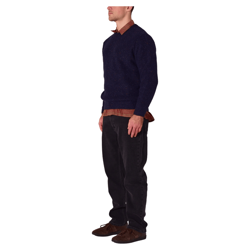 Side view of man in the Rollas Fishermans Tweed Crew in colour Dark Navy