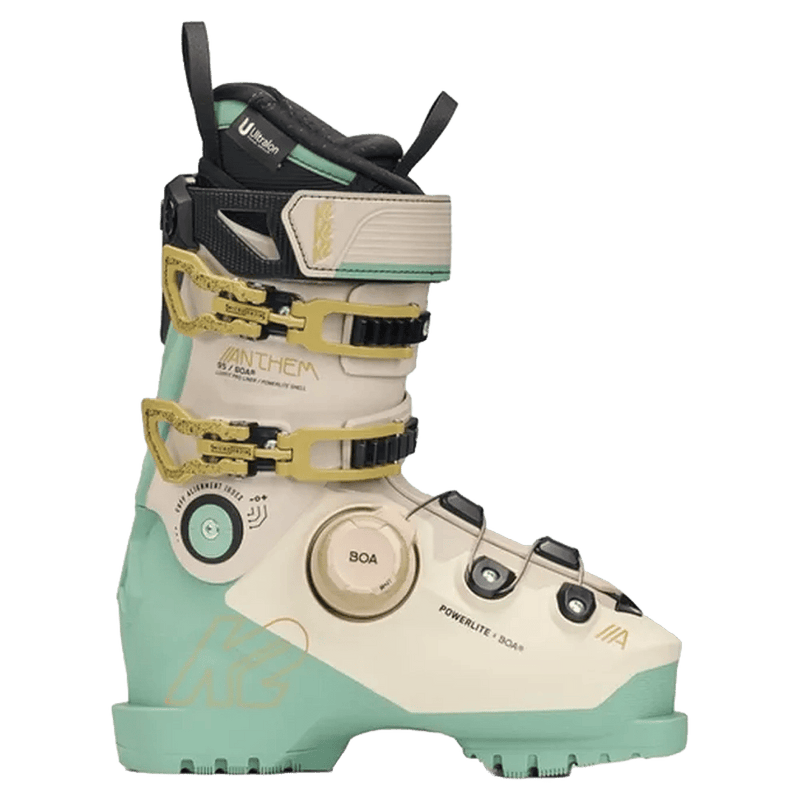 Side profile of a cream and mint green K2 Anthem 95 Boa ski boot with gold buckles and a BOA fit system dial.