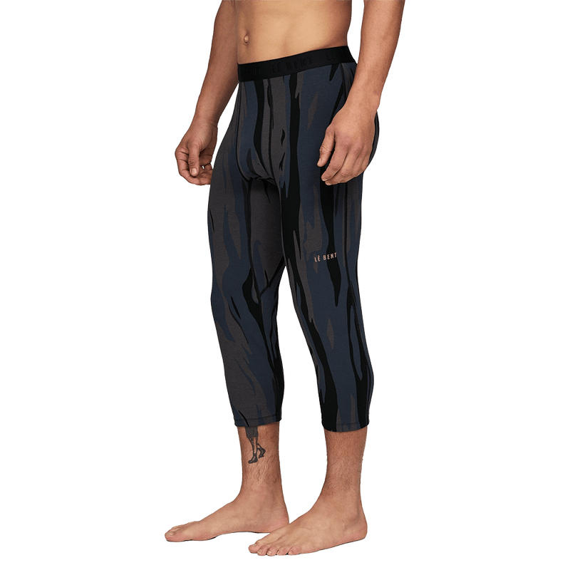 man wearing Le Bent Midweight Thermal 3/4 Bottom in ombre snow gum side view