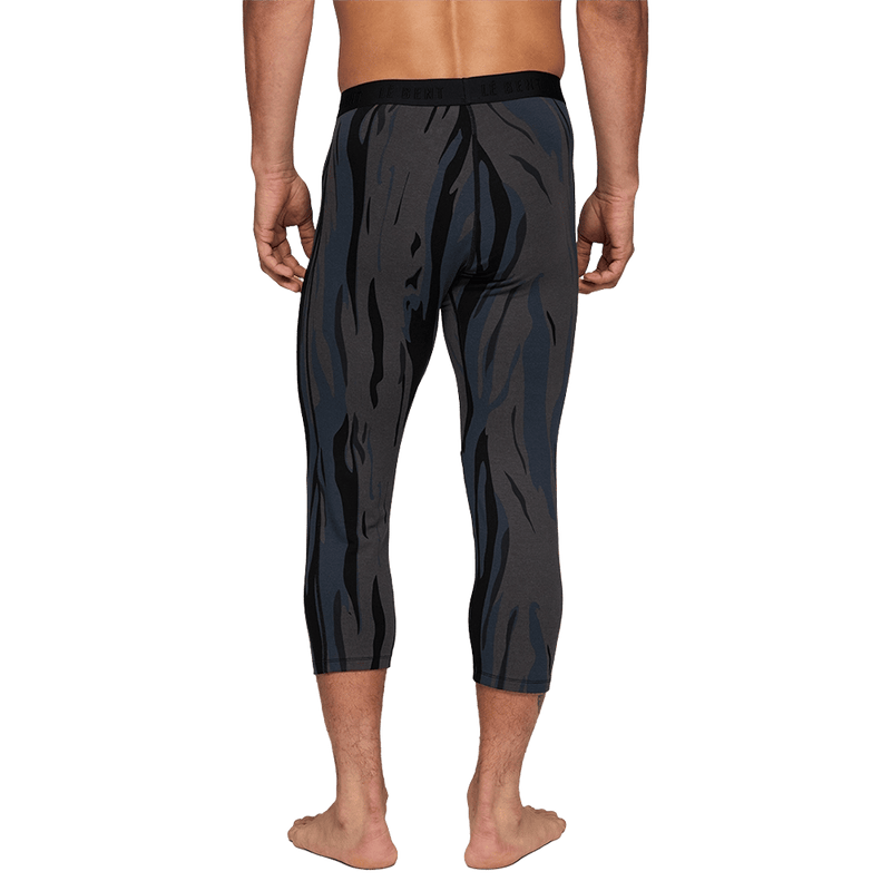 man wearing Le Bent Midweight Thermal 3/4 Bottom in ombre snow gum back view