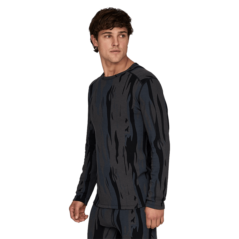 Man wearing Le Bent Midweight Thermal Crew ombre snow gum looking away