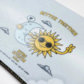 Nitro 2027 Optisym Snowboard - Womens graphic close up - cartoon sun with sunglasses hugging  a crescent moon with a peace sign