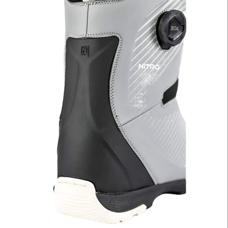 Close-up of a grey Nitro Club Boa snowboard boot showing the side Boa dial, black heel support, and white sole.