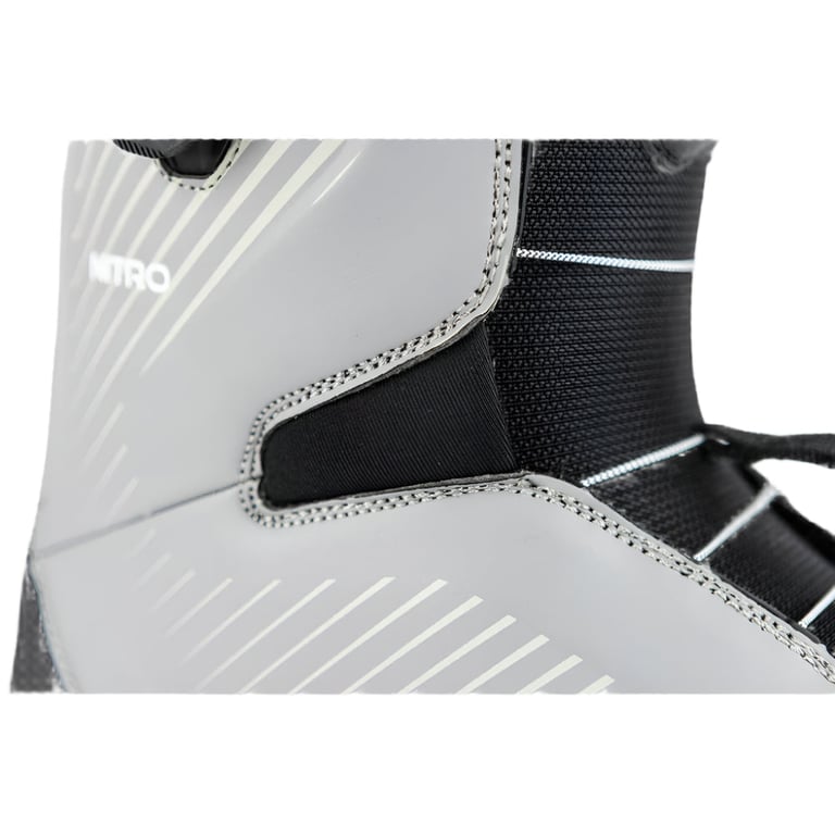 Close-up of a grey Nitro Club Boa snowboard boot with white stripes, black mesh tongue, and visible stitching.