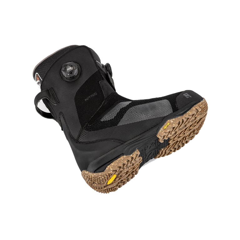 Nitro Skylab Boa snowboard boot in black with dual Boa dials and a brown Vibram outsole, shown from a low side angle.