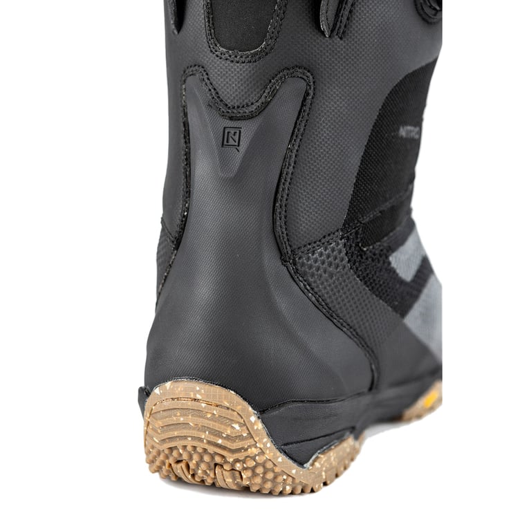 Heel detail of a black Nitro Skylab Boa snowboard boot with a textured tan rubber outsole and reinforced back spine.