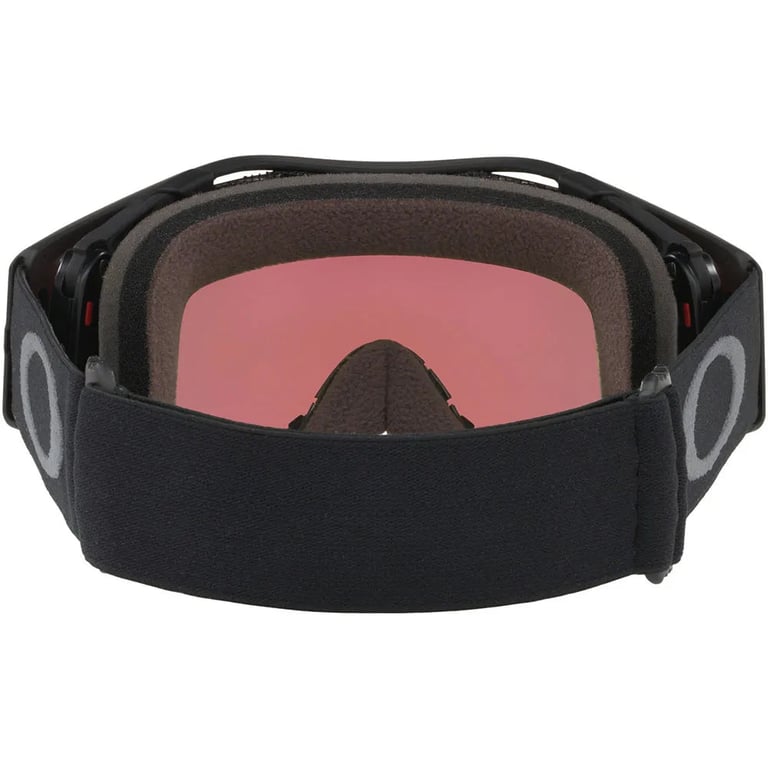 Oakley Airbrake MTB goggles rear view with black strap, grey logos, foam padding, and pink tinted lens.