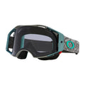 Oakley Airbrake MTB goggles with a teal frame, dark tinted lens, and grey patterned strap with a teal logo.