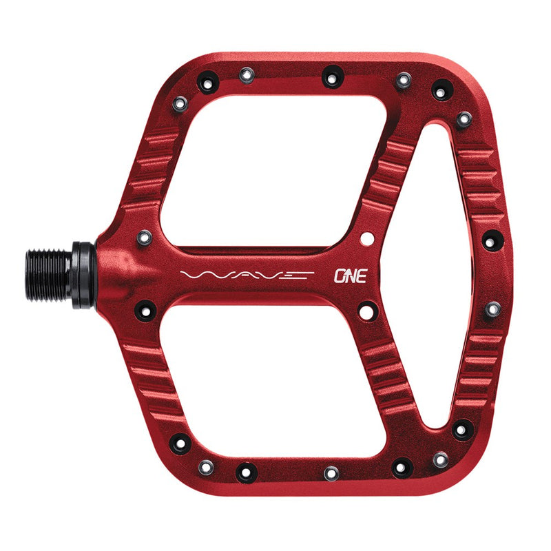 Red One Up Components Wave flat mountain bike pedal with thin aluminum platform and metal traction pins.