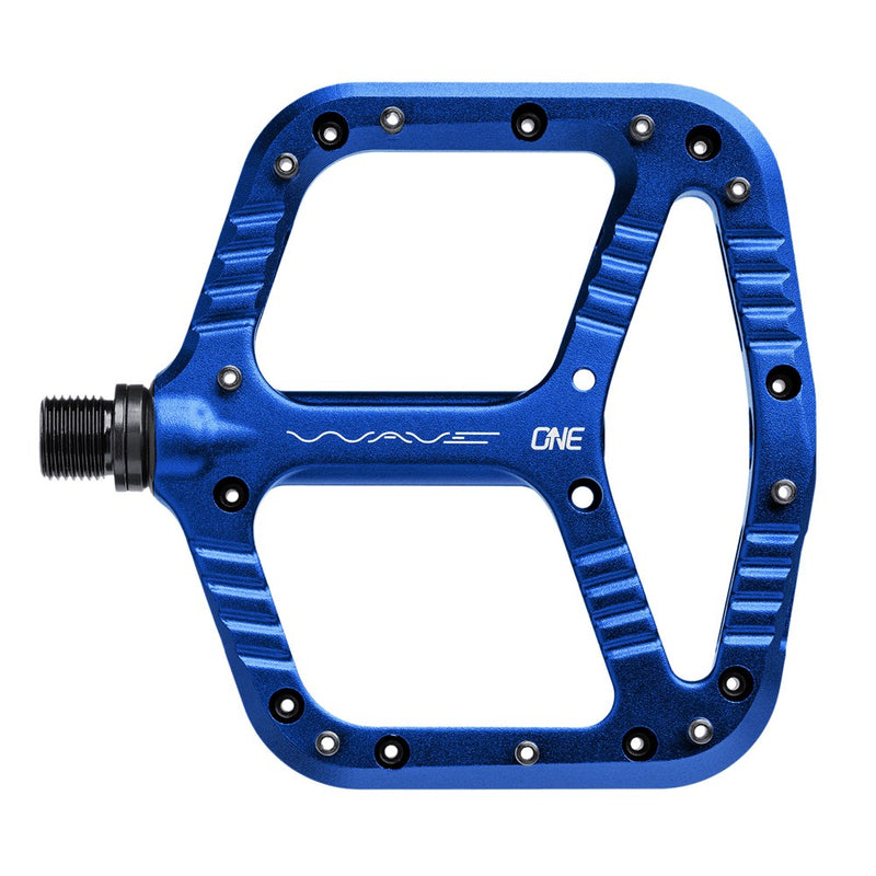 Blue One Up Components Wave flat mountain bike pedal with silver pins and textured aluminum platform.