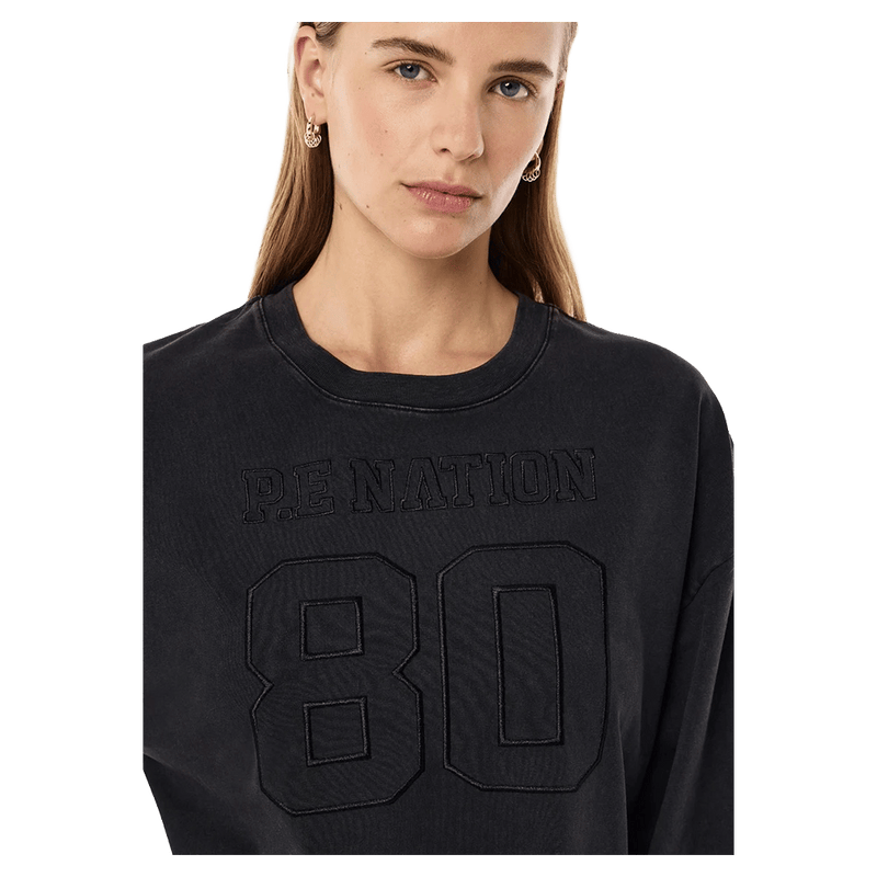 Close view of the PE NATION Oversized LS Washed Black Tee,  26/27 Womens's model