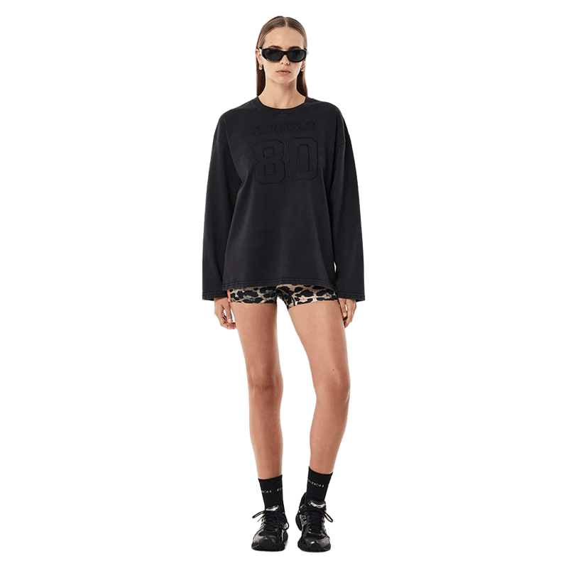 FAR view of the PE NATION Oversized LS Washed Black Tee,  26/27 Womens's model