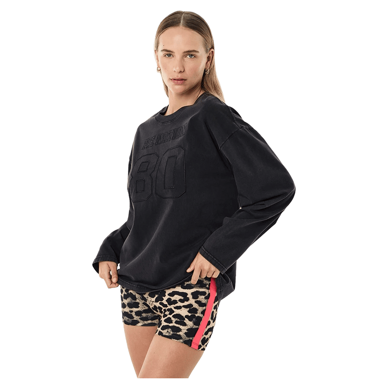 Side view of the PE NATION Oversized LS Washed Black Tee,  26/27 Womens's model
