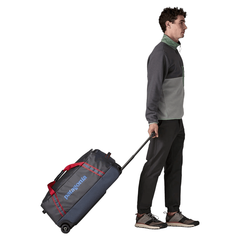 Rolling view of the Patagonia Black Hole®_Wheeled_Duffle_70L_SmolderBlue_AnimatedRed 49382 Bags,  26/27 Unisex's model