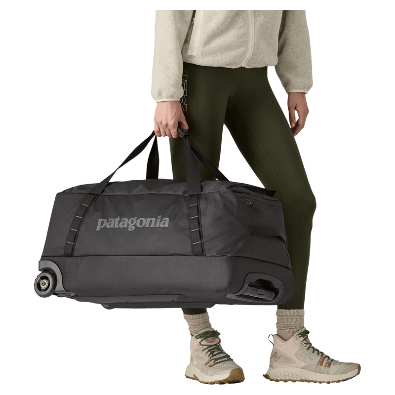 Carried view of the Patagonia Black Hole®_Wheeled_Duffle_70L_Black 49382 Bags,  26/27 Unisex's model