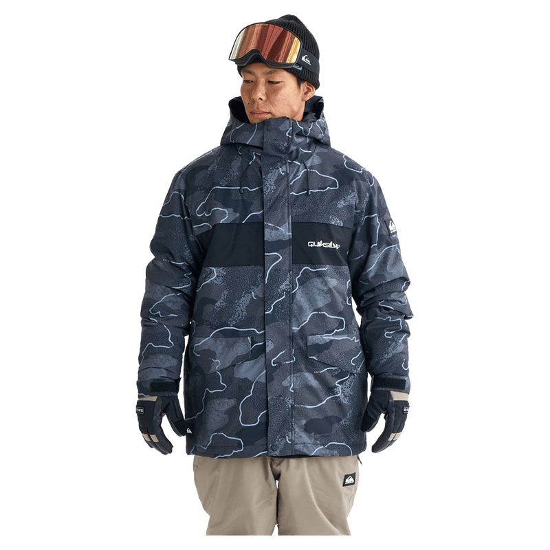 Quiksilver Mission Printed Snowboard Jacket in dark blue topographic print with hood and chest logo on a model.