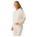 Woman wearing a cream Rip Curl Cala Nights textured hoodie with a hood and drawstrings in a relaxed, cropped fit.