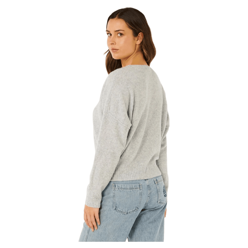 Rip Curl Emily light grey knit sweater for women, featuring ribbed cuffs and hem, shown from a back-side angle.