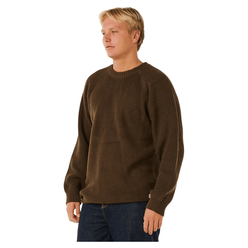 Man wearing a dark brown Rip Curl Premium Surf Knit Crew ribbed jumper with a crew neck.