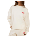 Rip Curl Surf Puff Inspired Crew in cream with a small red chest logo, worn by a woman.