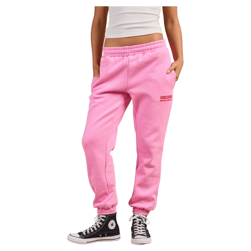 Bright pink Rip Curl women's trackpants with elastic waistband, side pockets, and cuffed ankles.