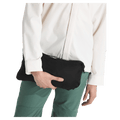 View of a woman carrying a fully packed Terra Peak Jacket for Women in Black from The North Face, the size of a small camp pillow