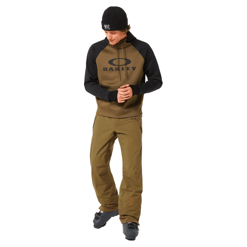 Full-body view of the Oakley Best Cedar Rc Insulated Ski Pants in Army Green colourway, mens's model