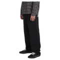 Side view of man wearing the Billabong Immortal Blast Trackpants in Black