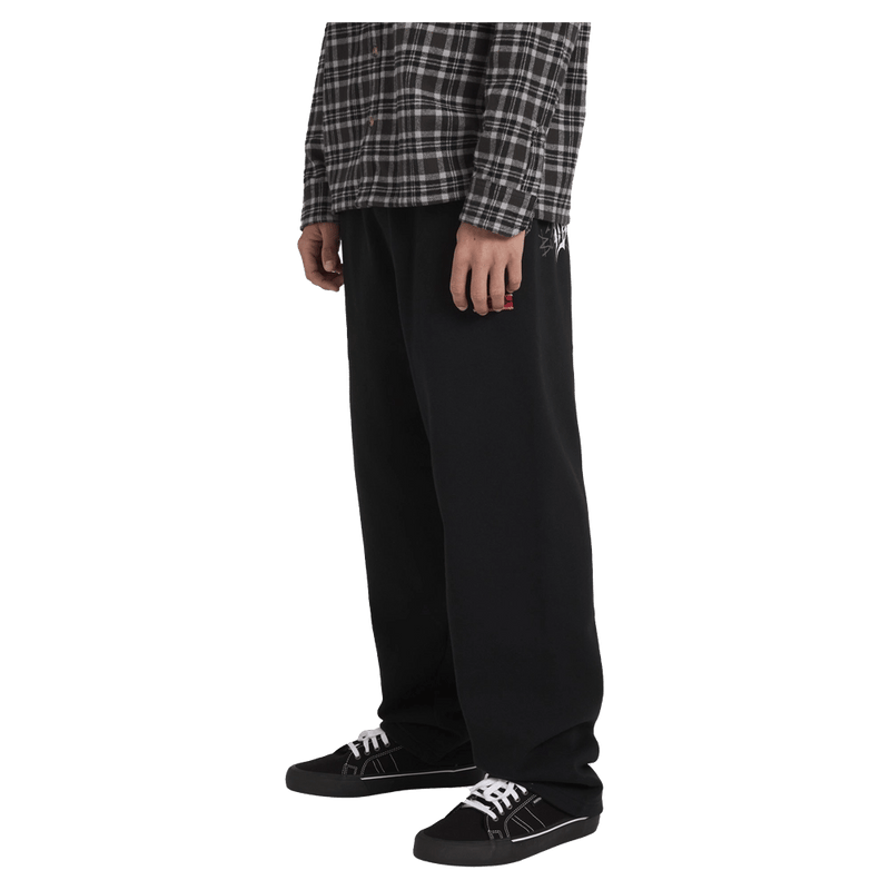 Side view of man wearing the Billabong Immortal Blast Trackpants in Black