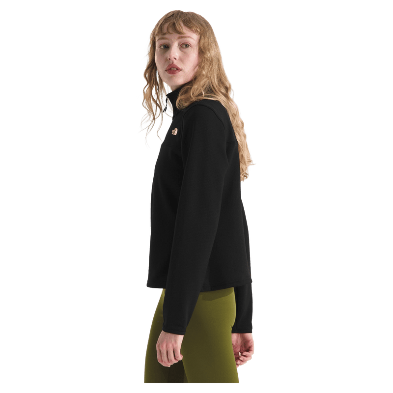 Side view of a woman wearing The North Face Cedar Trail Grid Fleece ¼ Zip Jacket for Women in Black