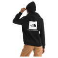 Rear view of a woman wearing The North Face Evolution Box NSE Hoodie for Women in Black featuring a box logo graphic in white and black.