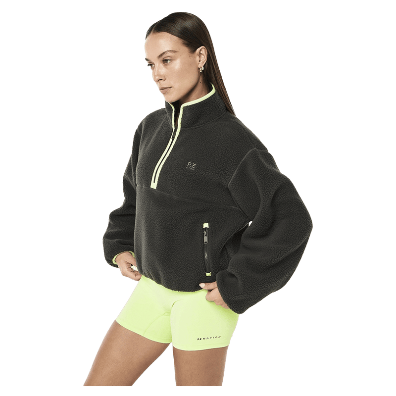 Side view of the PE NATION Verde Sherpa Quarter Zip Cavier/Washed Lime Jumper,  26/27 Womens's model