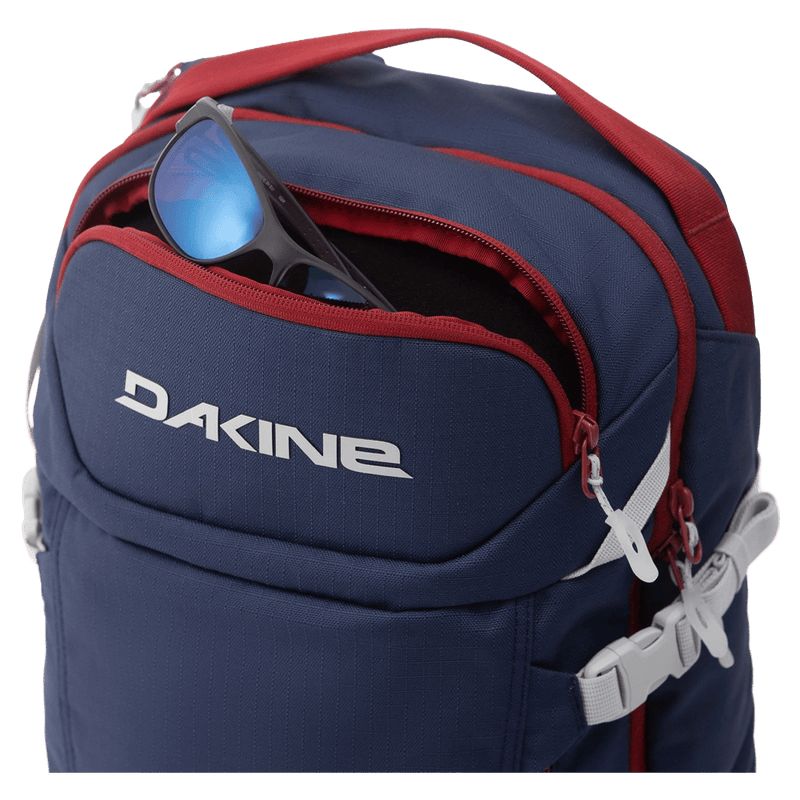 Pocket view of the Dakine Heli Pro 24L Backpack in NAVAL ACADEMY colourway, unisex's model