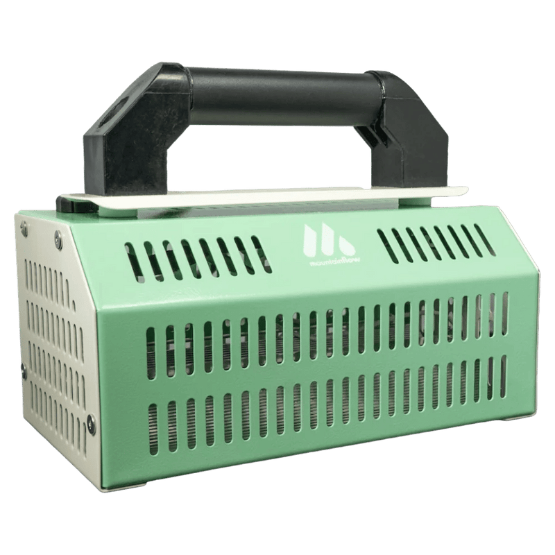 Side view of Mountain Flow Infrared Waxer featuring a big black handle and green sides with ventalation vents