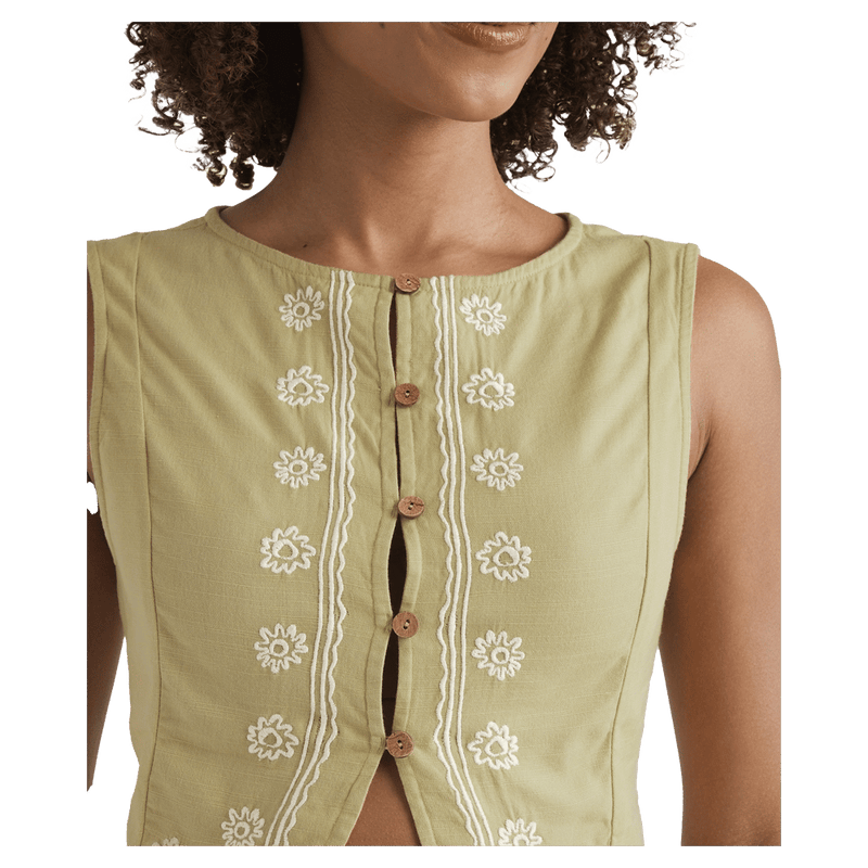 Cropped detail view of a woman wearing the Your Crush Shirt - Womens from Billabong in Light Olive. Featuring line and floral embroidered detail in contrast white, small round wood look button closure, round neckline and sleeveless cut.